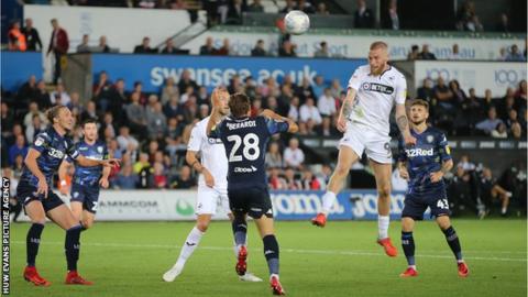 Unbeaten Leeds go top with comeback draw at Swansea