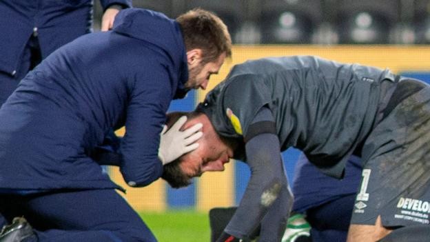 Kamil Grabara: Huddersfield Town goalkeeper stays in hospital after head injury