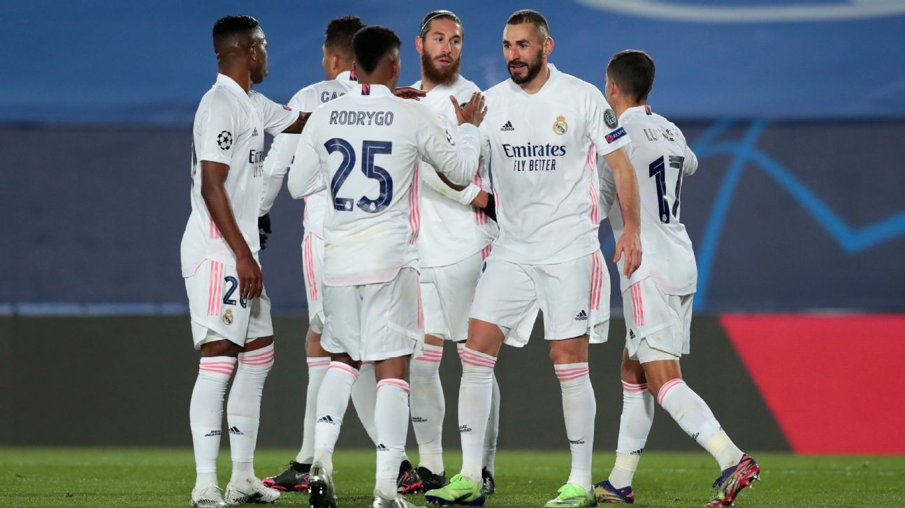 Benzema double sees Madrid sneak through